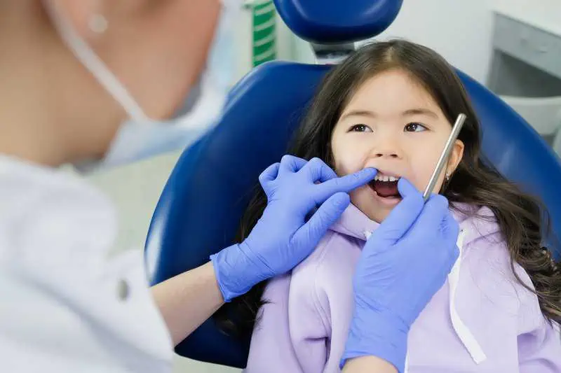 Pediatric dentist doing a routine dental check-up for a child in Patna