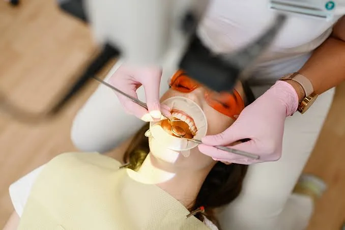Dentist examining mouth ulcer