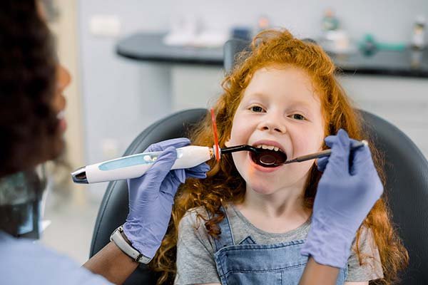 Dentist providing preventive and restorative dental treatment for a child in Patna