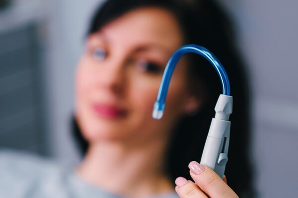 Dentist cleaning and disinfecting infected root canal during treatment in Patna