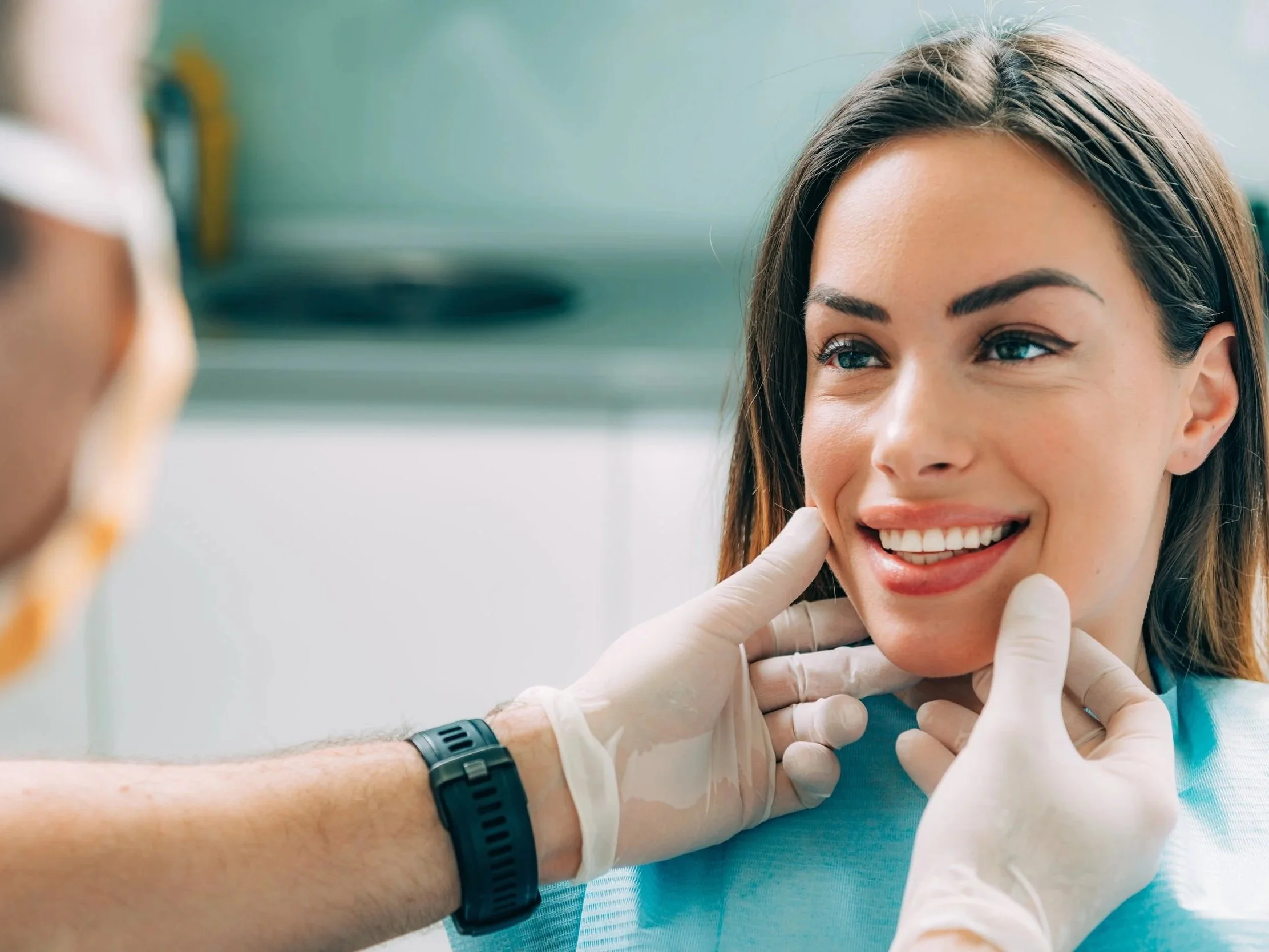 Dentist performing a smile assessment for a patient during cosmetic dentistry consultation in Patna.
